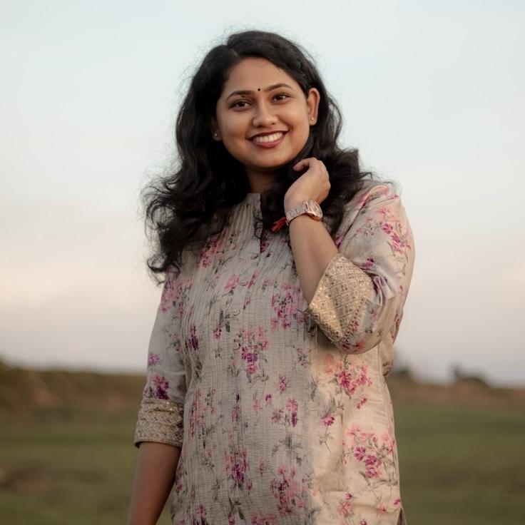 Avery Chen, Lead Design Curator at HarborPanelWorks, reviewing corporate floral arrangements